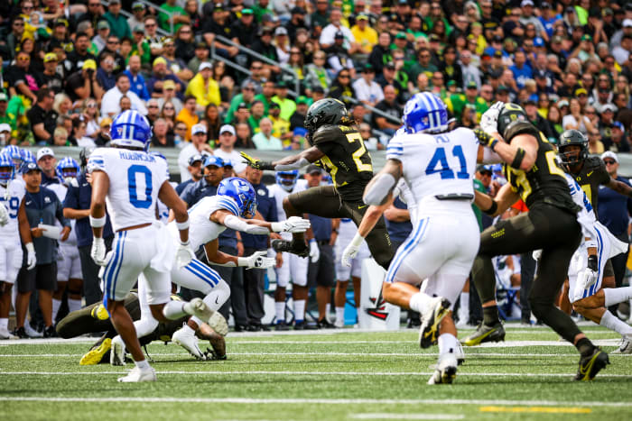 Oregon Ducks running back Noah Whittington attempts to hurdle a defender against the BYU Cougars at Autzen Stadium.
